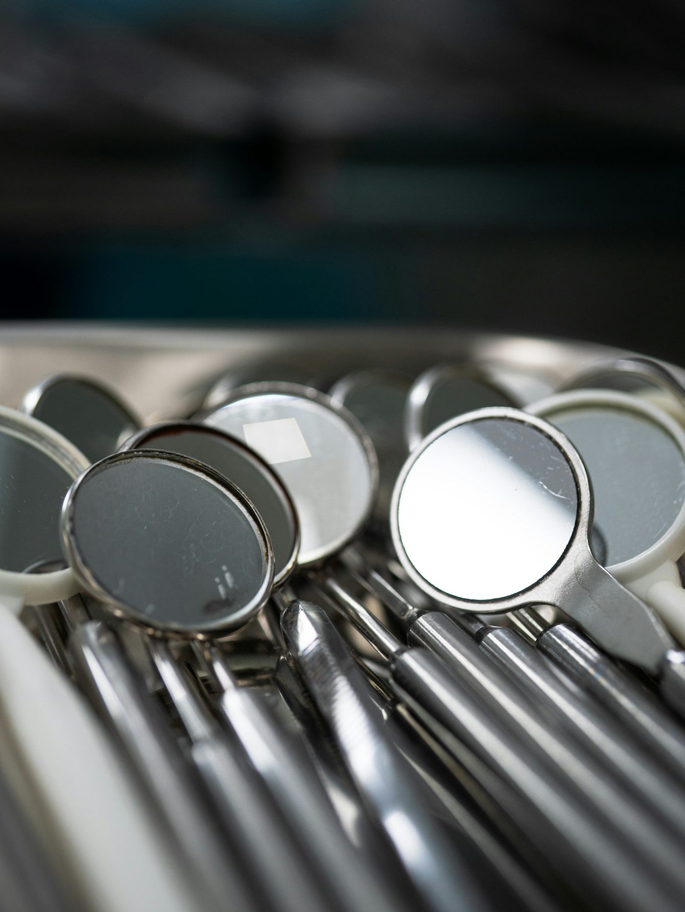 Dental mirrors and instruments laid out in a steel tray